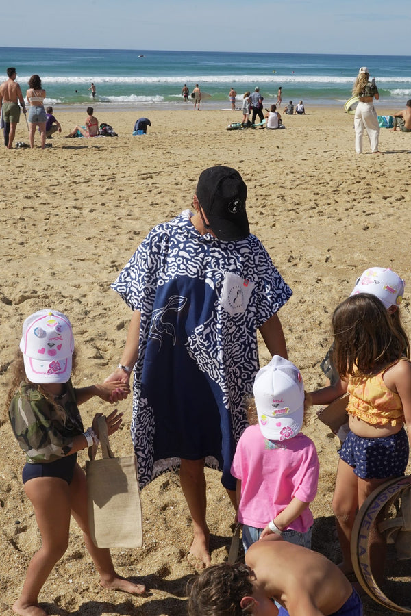 Maud Le Car and some children on the beach during Mermaid Day