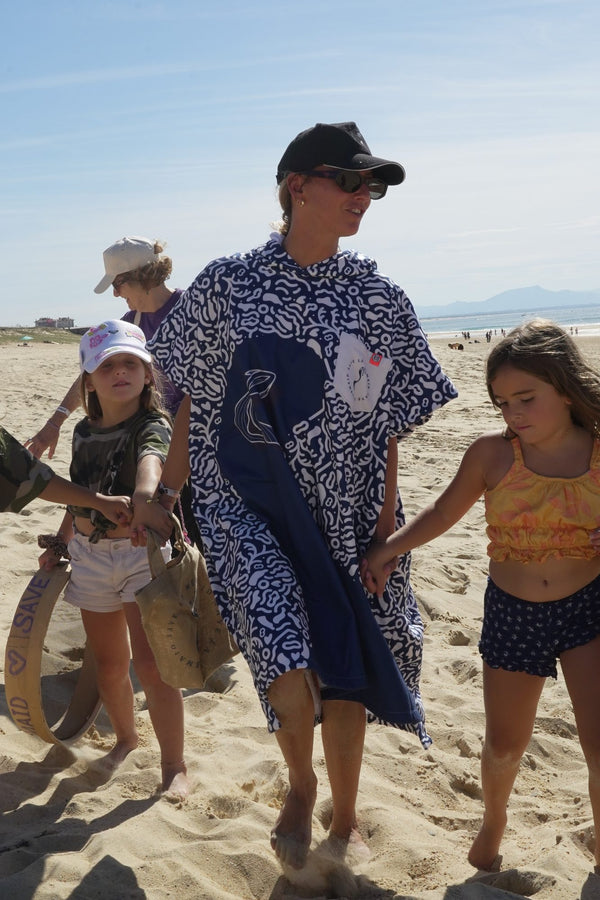 Save La Mermaid poncho worn during a walk on the beach