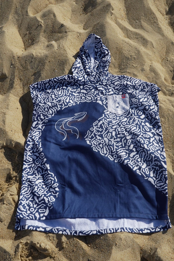 Save La Mermaid poncho spread out on the sand